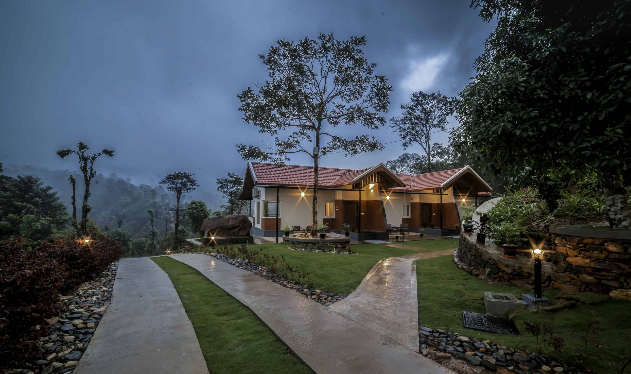 Premium cottages at night amid greenery. RiverMist, Chikmagalur.