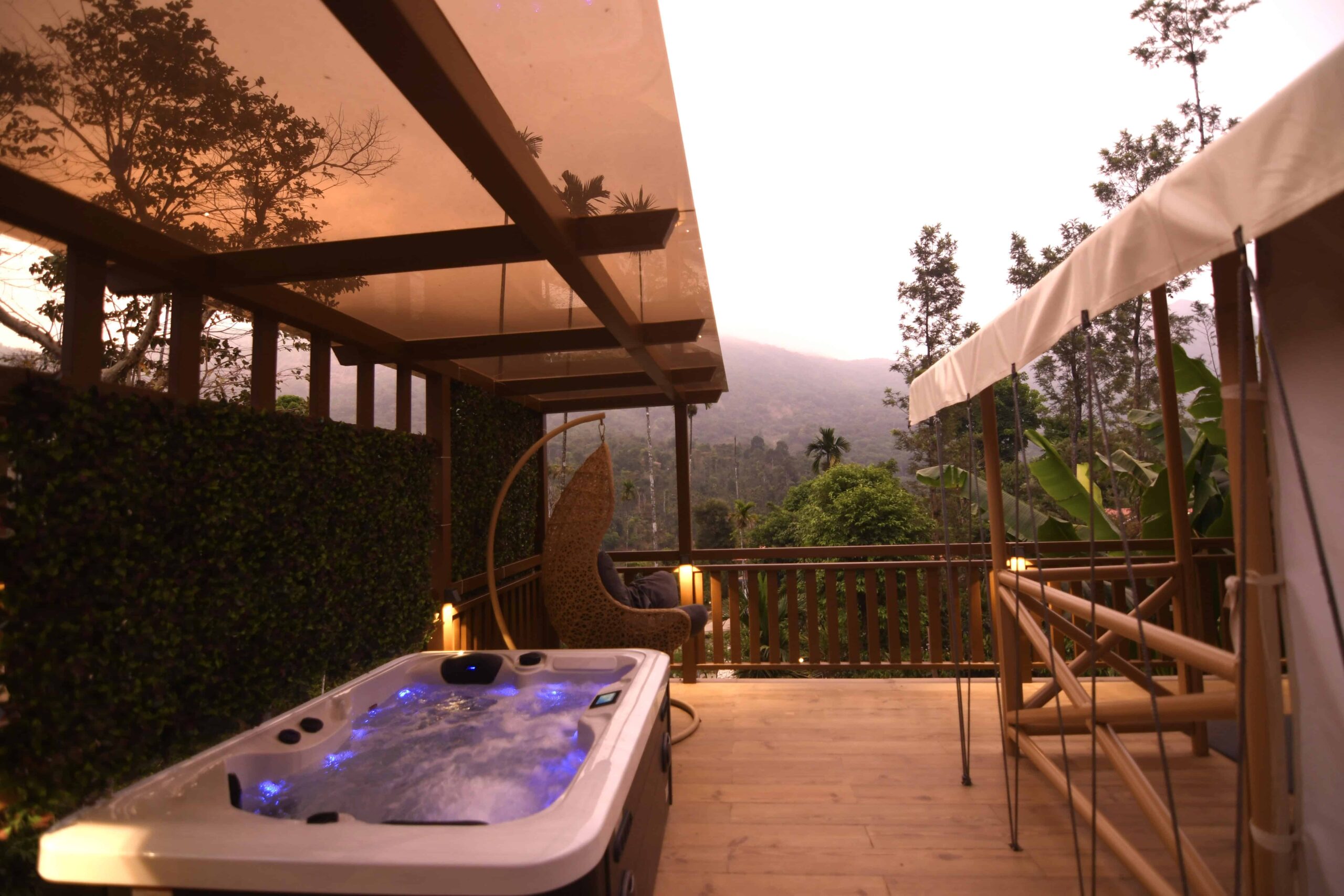 Private deck with spa tub and hanging chair. RiverMist Resorts.