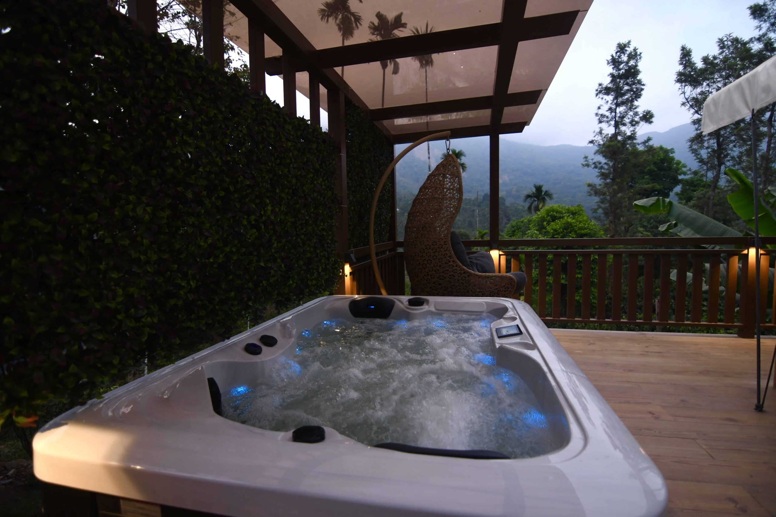 Outdoor hot tub on deck with mountain view. RiverMist Resorts.