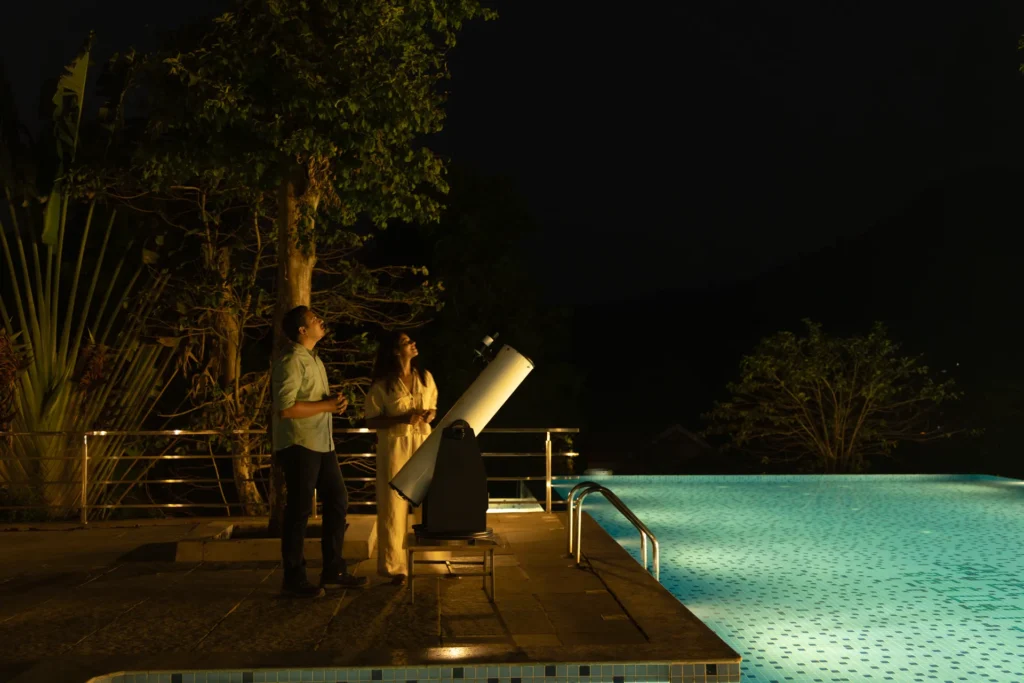 Guests stargazing by the pool at RiverMist Resort