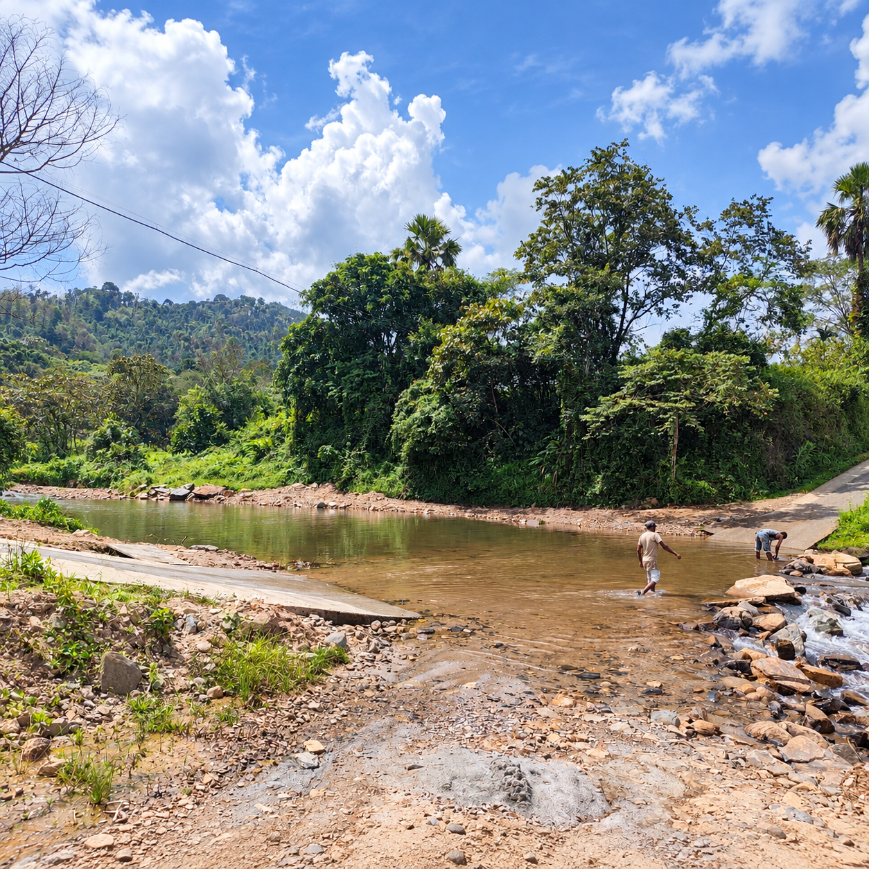 RiverMist shallow river crossing surrounded by rocky banks, lush trees and hills